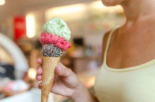 Person Holding Ice Cream With Different Flavors