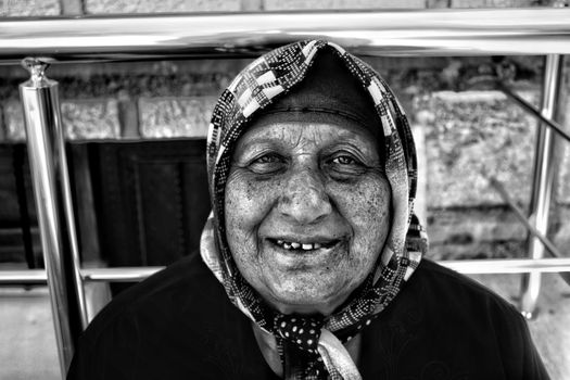 A Grayscale Photo of an Elderly Woman Wearing Scarf