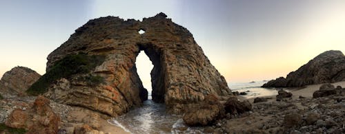 Free stock photo of arch, beach, boulder