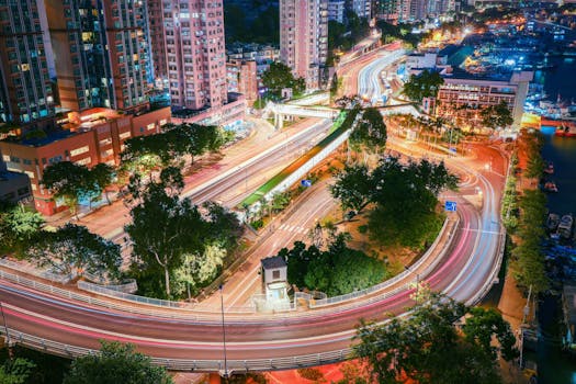 Aerial view of Hong Kong with vibrant light trails creating a dynamic cityscape.