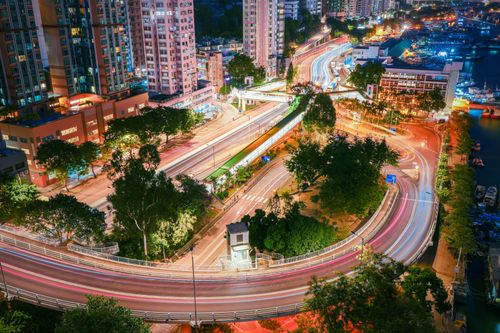 Free Aerial view of Hong Kong with vibrant light trails creating a dynamic cityscape. Stock Photo