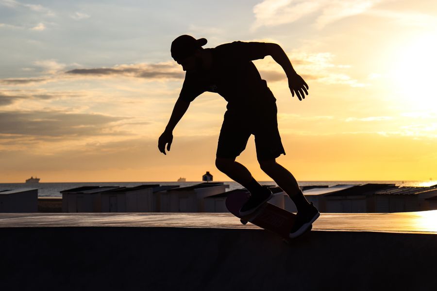Skateboarder silhouetted against a sunset sky, photo by Ruben Christen on Pexels