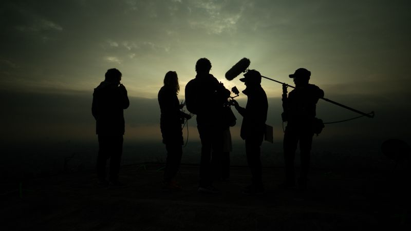 Film crew shooting on location at golden hour