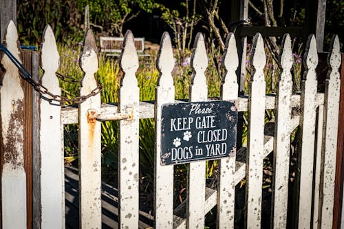 A Warning Signage on a Wooden Fence