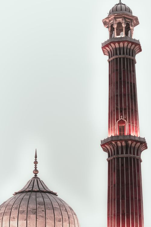 Free Low angle view of Jama Masjid's iconic minaret and dome in New Delhi, India. Stock Photo