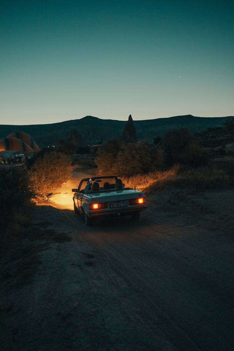 Car Driving With Lights In Night Field