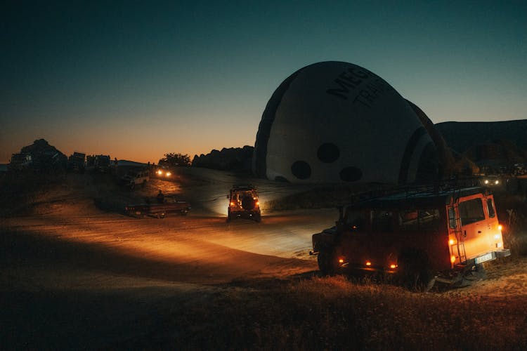 Cars Driving On A Construction Site At Dusk