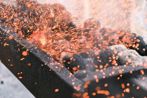Free Dynamic image of a charcoal grill with vibrant sparks flying, capturing the essence of grilling heat. Stock Photo