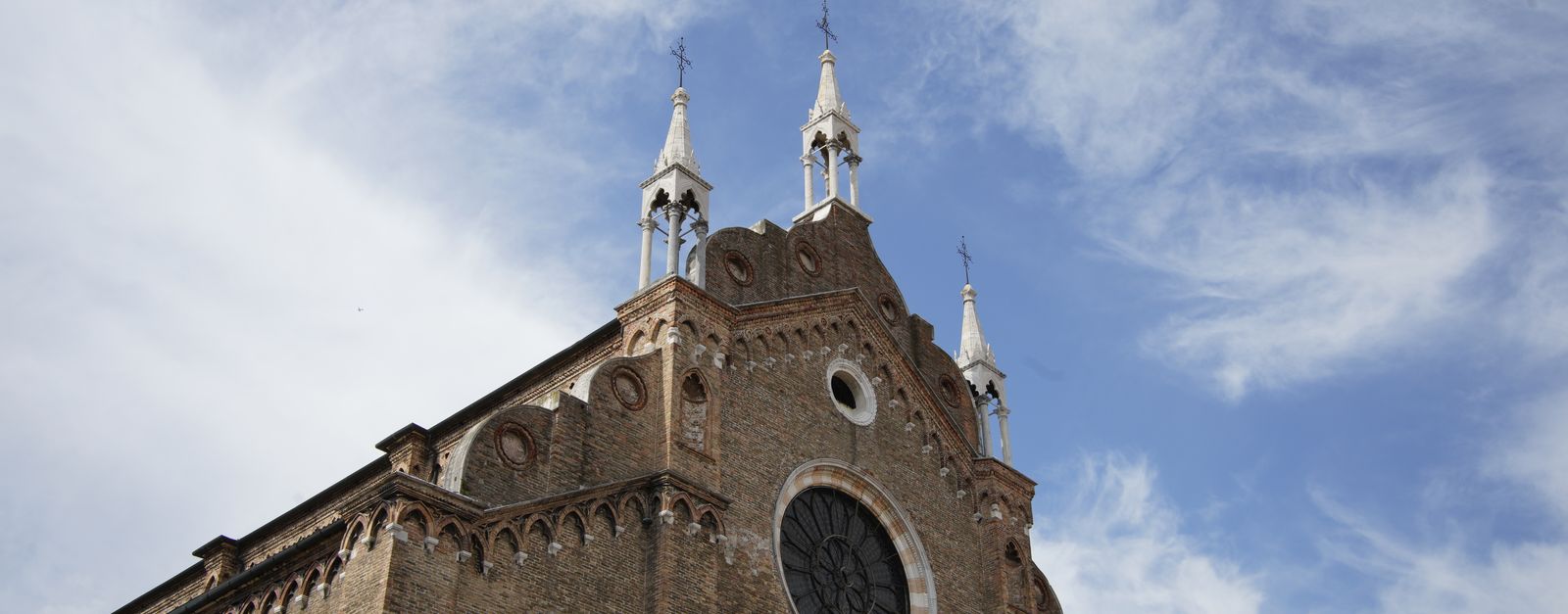 Stunning view of Santa Maria Gloriosa dei Frari against a clear blue sky.