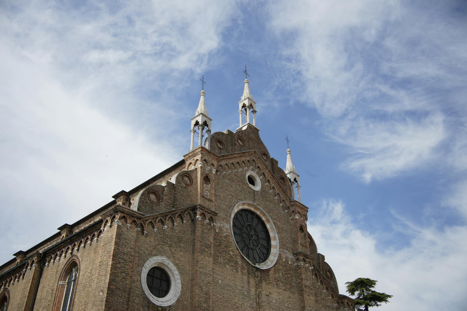 Stunning view of Santa Maria Gloriosa dei Frari against a clear blue sky.