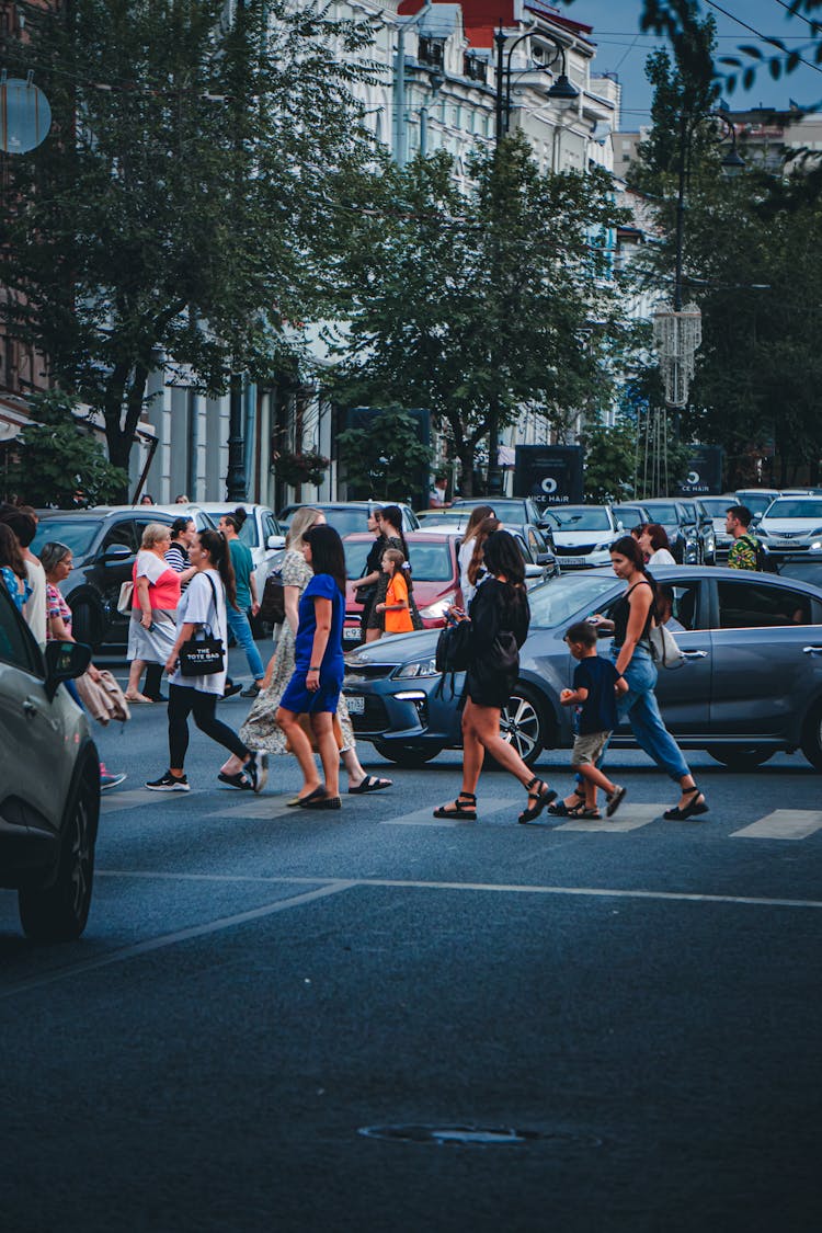 People Walking On The Street Near The Cars