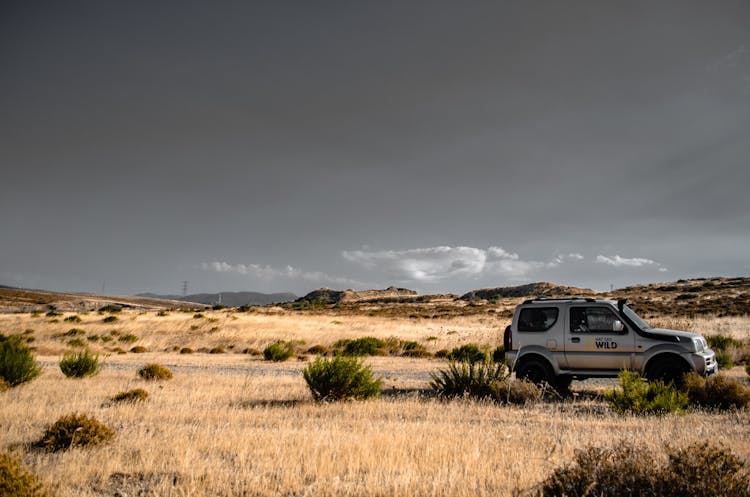 Offroad Car Driving In Desert Landscape