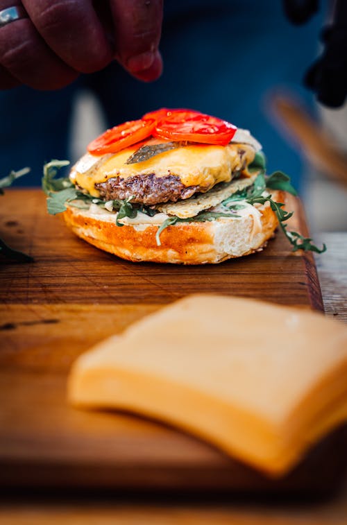 Hamburger and Cheese on Brown Wooden Chopping Board