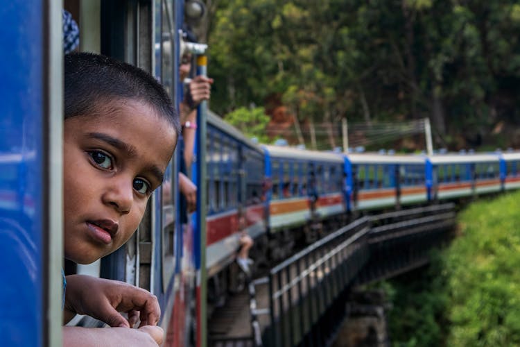 A Boy Riding A Train