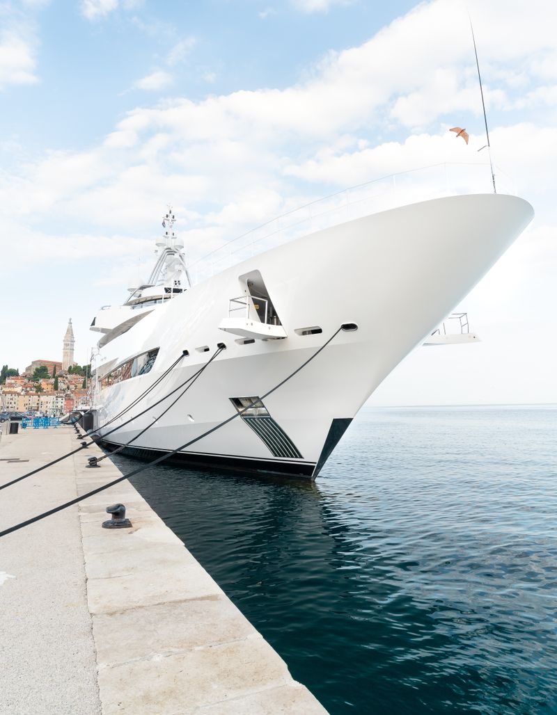 White luxury yacht moored in harbor