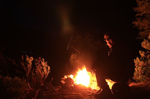 Man Sitting in Front of a Bonfire