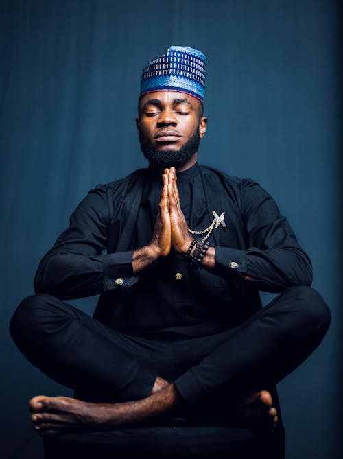 Close-up Photo of Man in Traditional Wear doing Yoga 