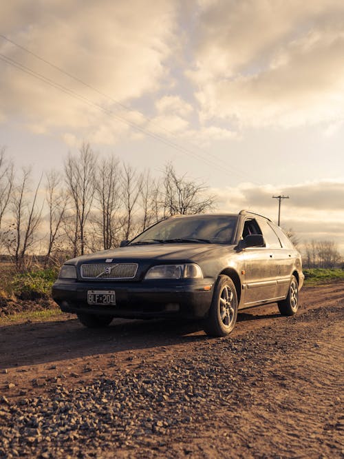 A Car on Brown Dirt Road