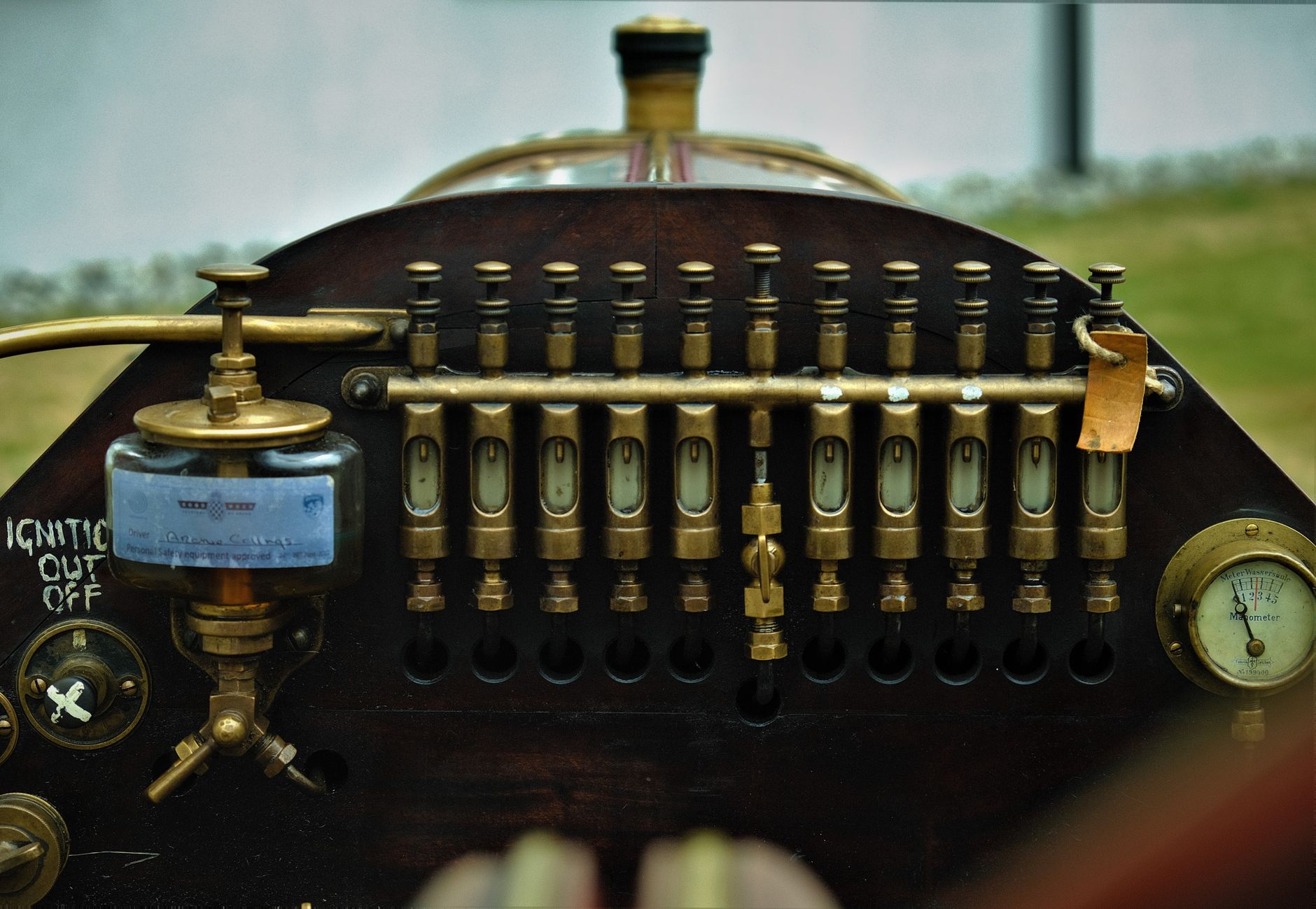 Close-up view of a vintage train control panel with brass components and a retro design.