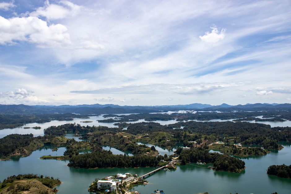 Best Guatape Private Tour with Helicopter Ride from Medellin Review 2026 - Scenic aerial view of Peñol Reservoir, lush landscapes under a bright sky.
