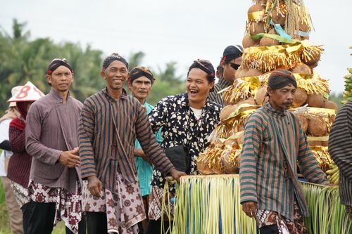Free Men in traditional costumes celebrating a harvest festival with colorful decorations. Stock Photo