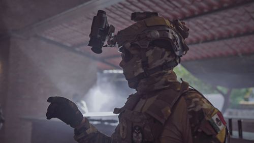 Free Profile of a soldier in tactical gear indoors, emphasizing readiness and security. Stock Photo