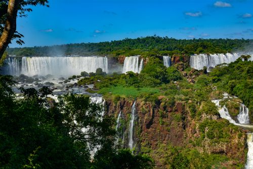 Free Experience the majestic Iguazu Falls surrounded by lush greenery in Argentina. Stock Photo
