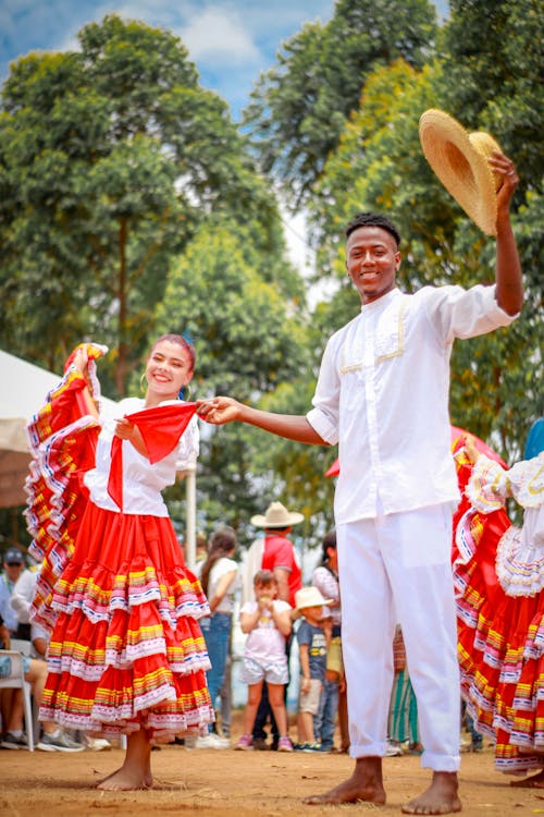 Man and Woman in Traditional Wear Dancing