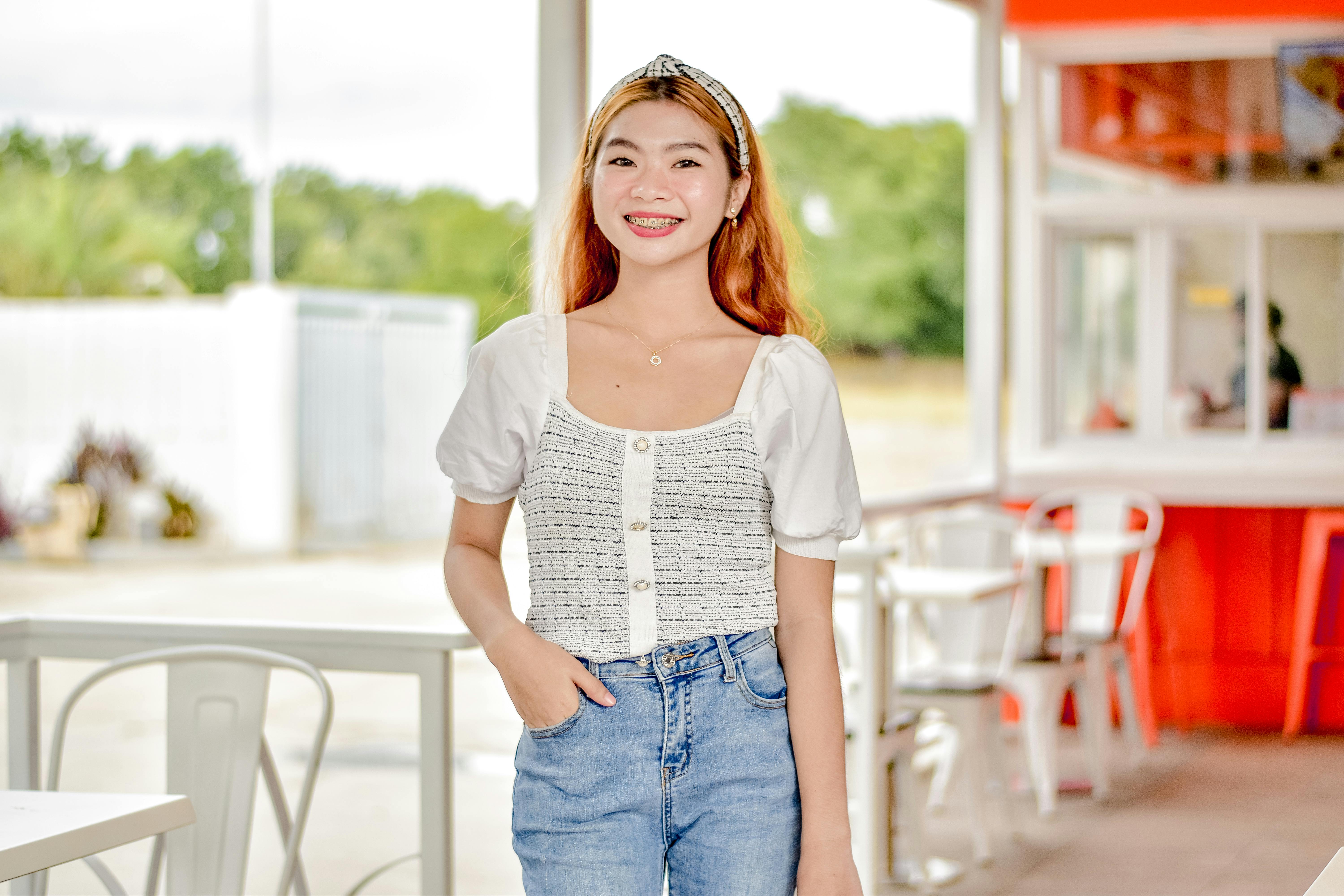 smiling woman with hand in her pocket