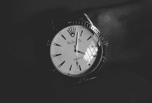 Round White Silver-colored Rolex Analog Watch Displaying 4:03 Time