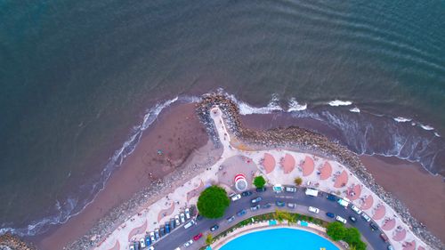 Free Aerial shot of a curved beachfront and ocean waves in Puntarenas, Costa Rica. Stock Photo