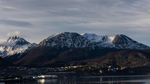 Snow Capped Mountains Under the Cloudy Sky 