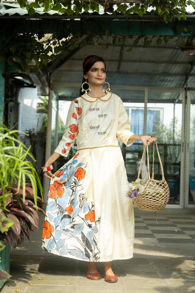 Woman In Traditional Costume Posing In Garden