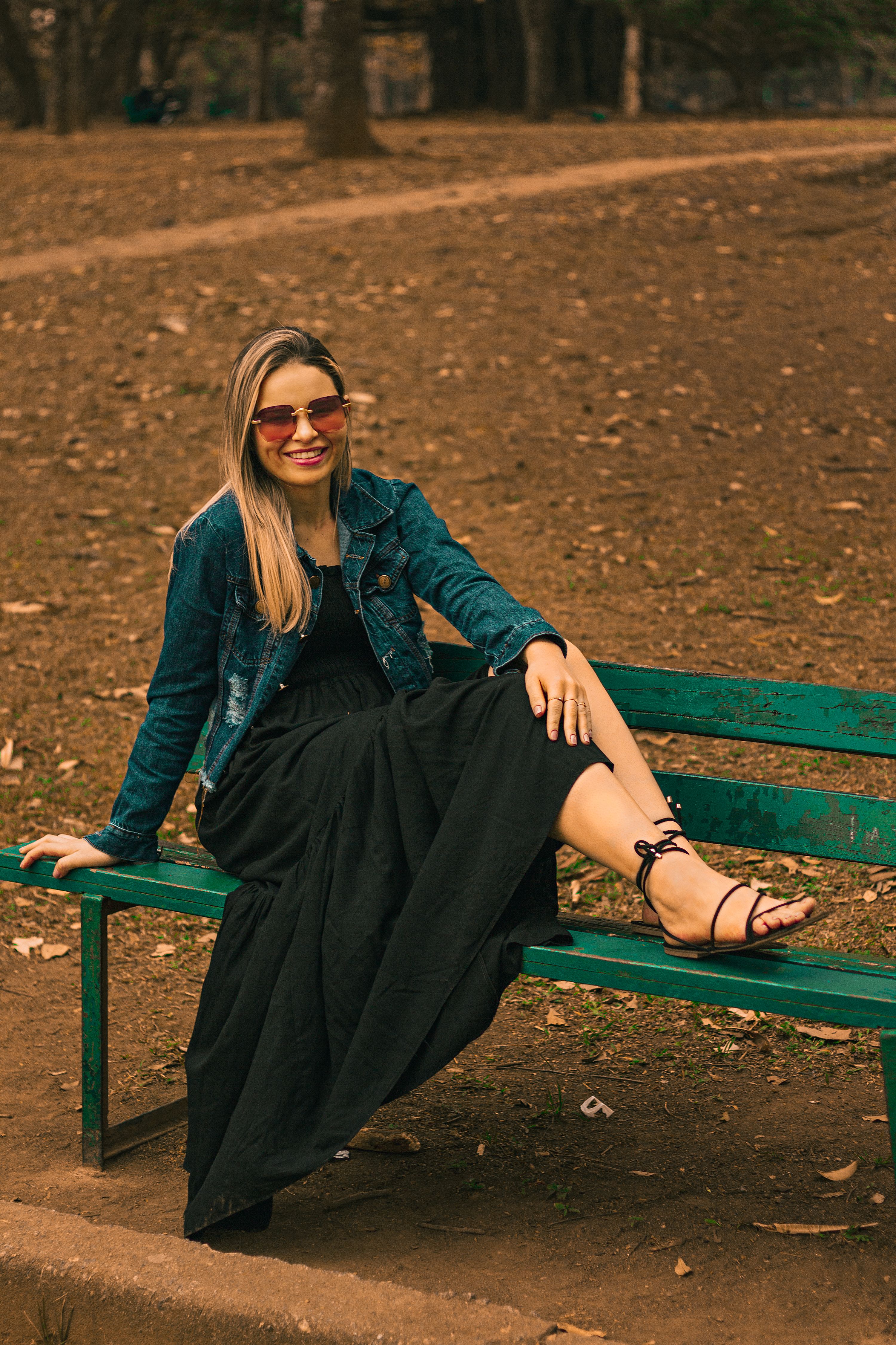 Woman in Blue Denim Jacket Sitting on Concrete Bench · Free Stock Photo