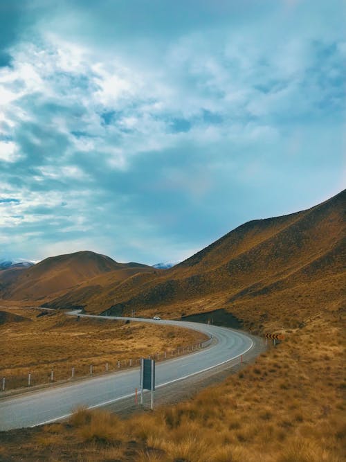 Road Surrounded By Brown Mountain