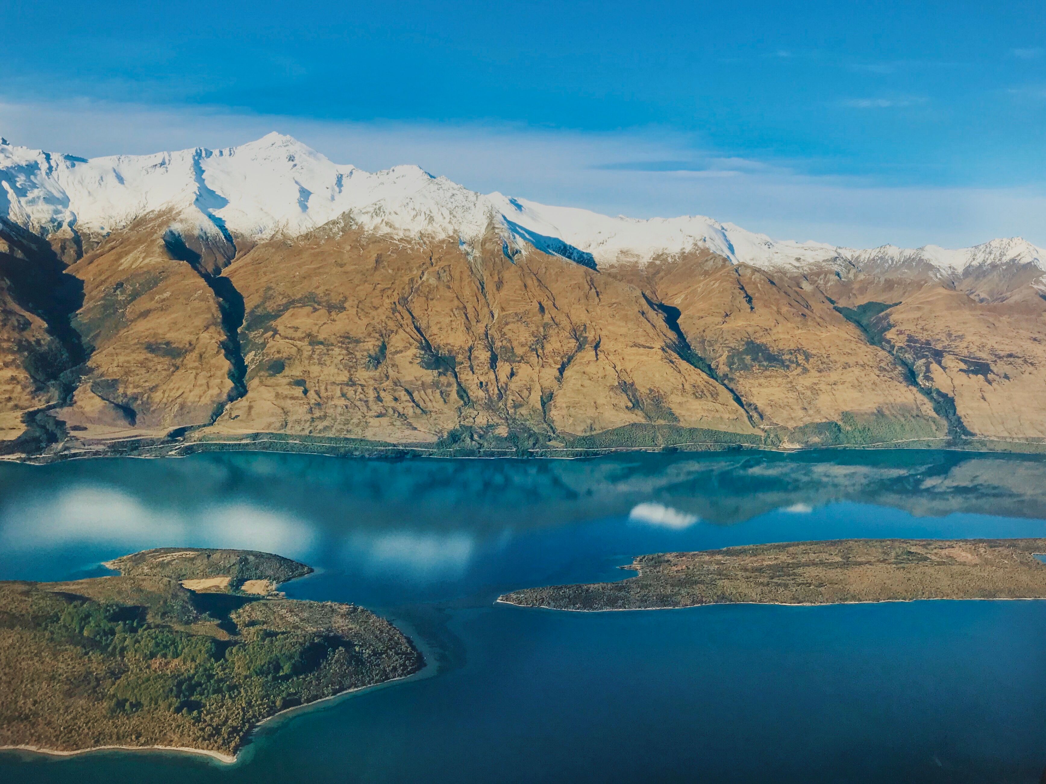 Amazing Tasman Glacier Heli-Hike Tour from Queenstown Review: The Ultimate New Zealand Adventure Review 2026 - Scenic aerial shot of Lake Wakatipu with surrounding snow-capped mountains in Southland, New Zealand.