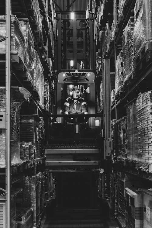 Man in Machine Working on Warehouse