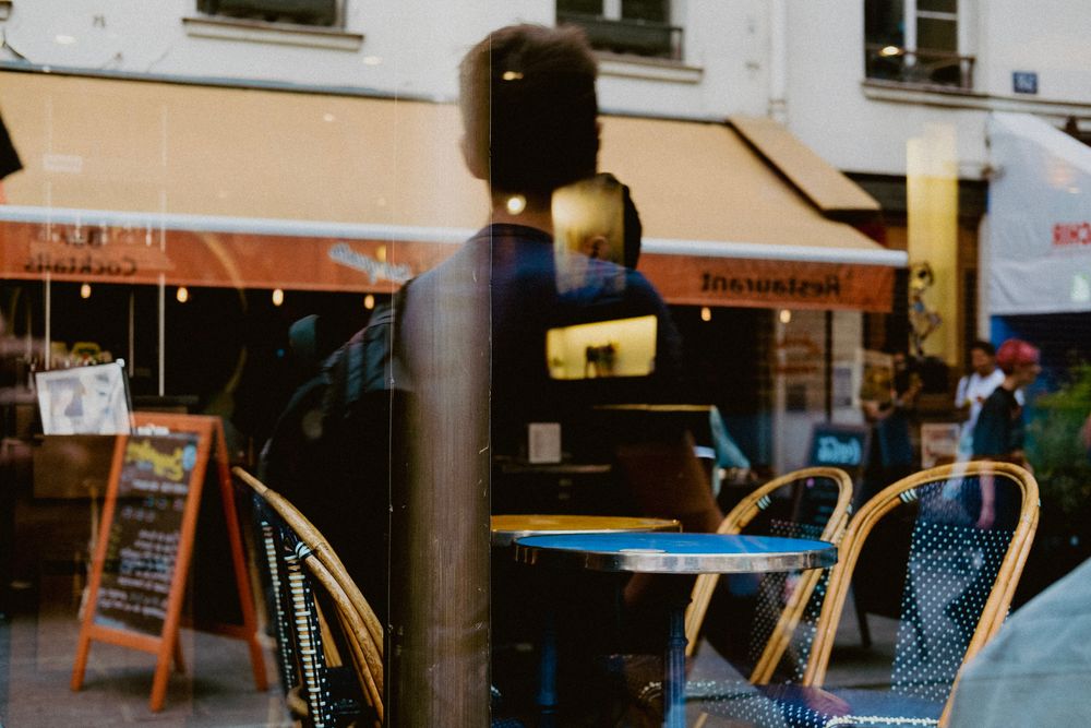 Urban scene with reflections in a café window