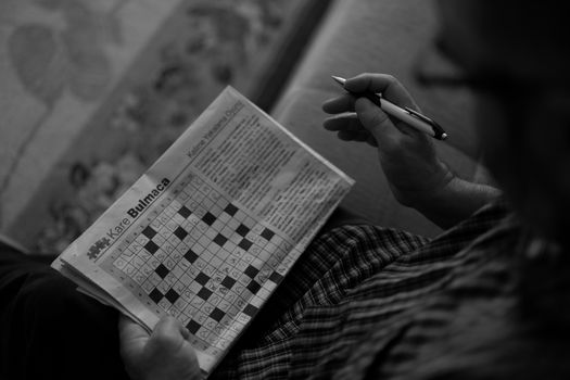 A person solving the LA Times crossword as a daily mental warm-up to prepare for the workday.