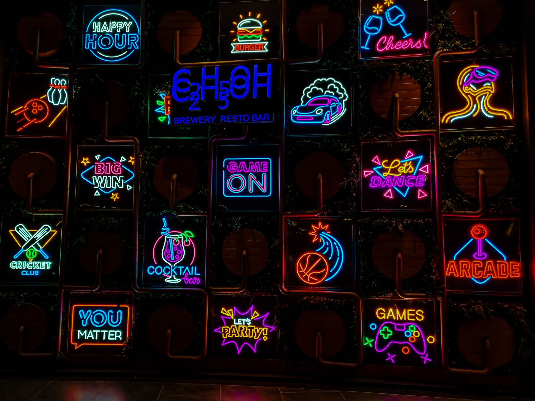 Neon signage and pub frontages of Sector 29 leisure district