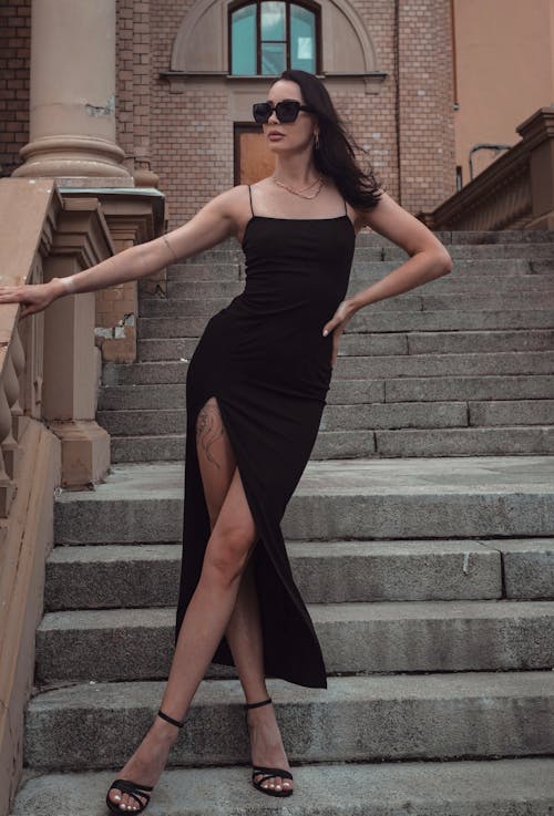 Woman in Black Dress Standing on Stairs