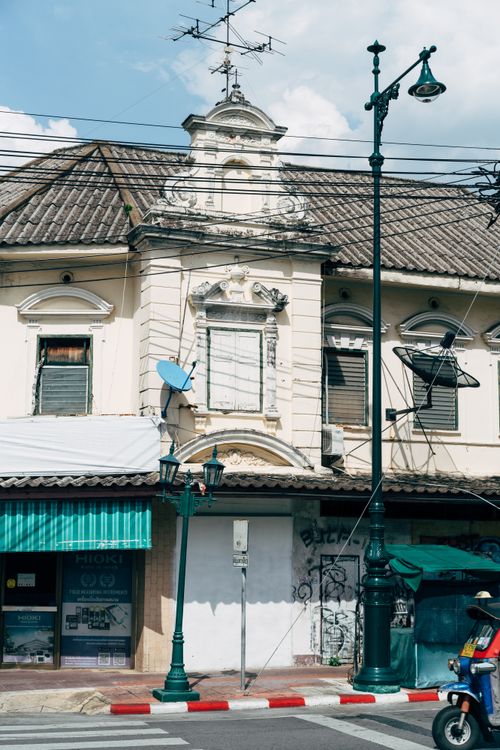 Free A street view featuring colonial architecture with vintage details and a Vespa on a sunny day. Stock Photo