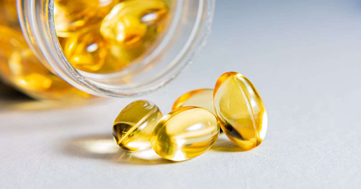 High-quality close-up of transparent softgel capsules spilled from a glass jar, showcasing vitamins or supplements. - Evidence evidence guide for fish oil triglycerides randomized trial