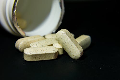 Medicine Capsules on the Black Background