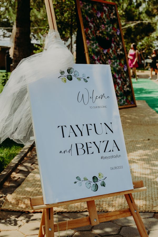Wedding welcome sign on a wooden easel with floral decor