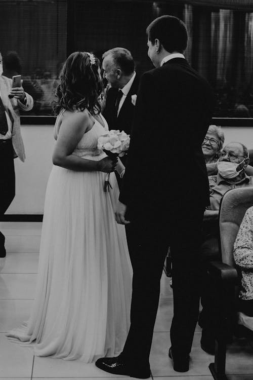 Grayscale Photo of a Couple Standing Together