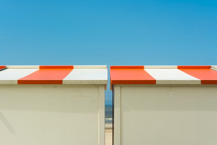 Wooden Booths On Beach Against Blue Sky