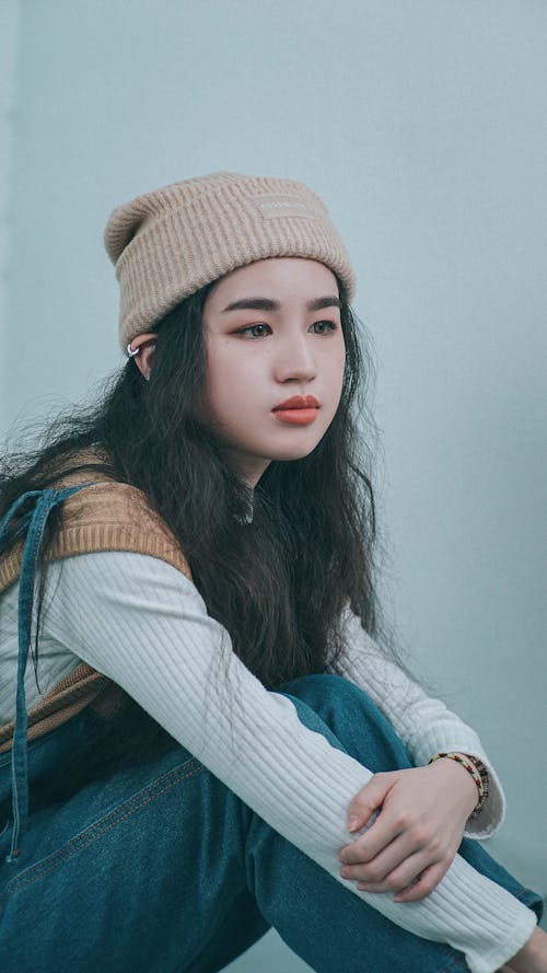 A Woman in White Long Sleeves Wearing Knitted Cap