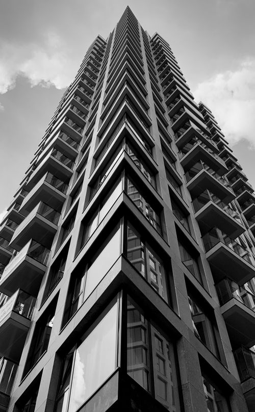 Free Black and white vertical shot of a high-rise building in The Hague, Netherlands. Stock Photo