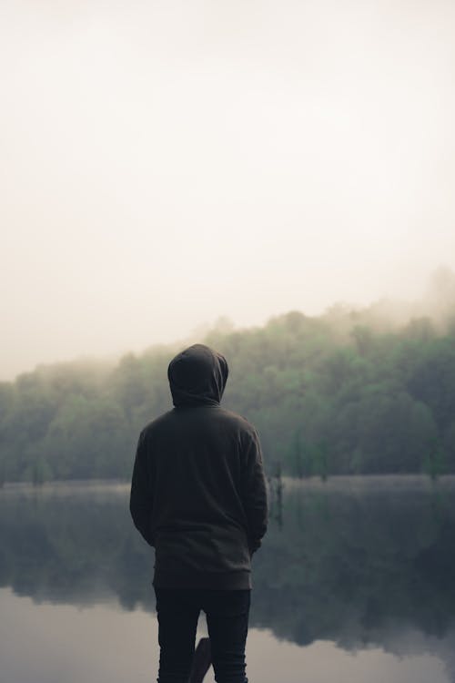 Person Wearing Hoodie Standing near a Lake